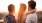 two men and a girl watch the sunset