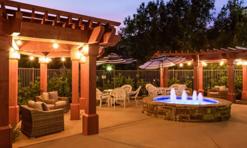 water fountain surrounded by pergola covered seating areas