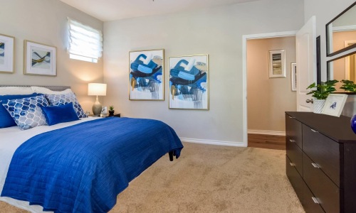 a bedroom with a bed and a fan