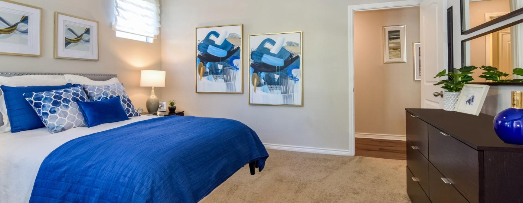 a bedroom with a bed and a fan