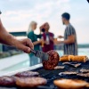 a person cooking food on a grill