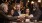 a group of people toast around a bar